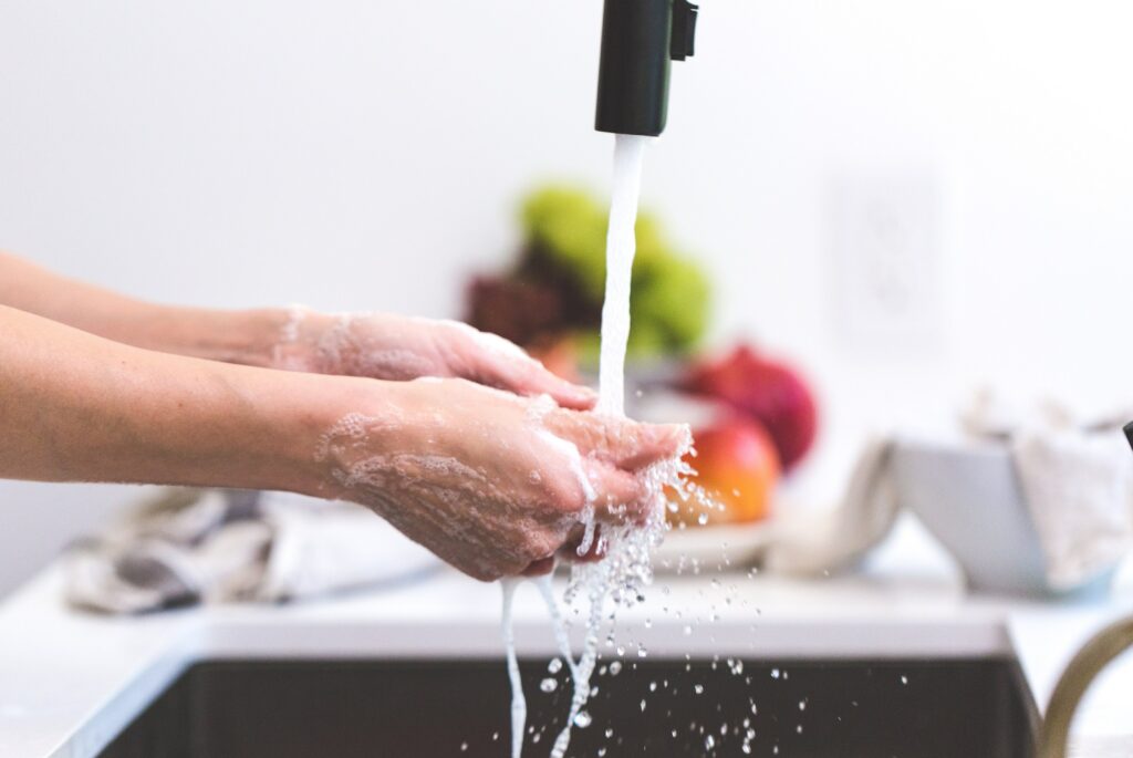 Washing hands using kitchen faucet